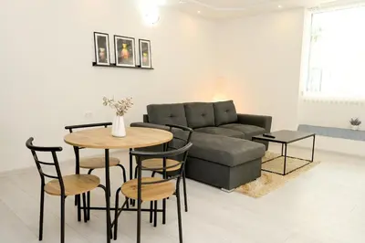 a living room with a couch and a table and chairs at Apartman Leo Jajce in Jajce