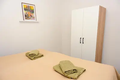 two towels sitting on top of a bed in a room at Apartman Leo Jajce in Jajce