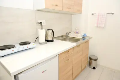 a kitchen with a sink and a counter top at Apartman Leo Jajce in Jajce
