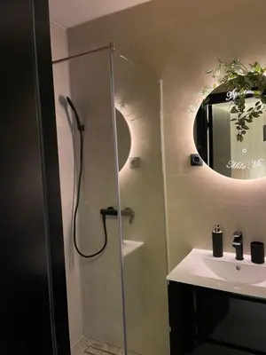 a bathroom with a shower and a sink at Apartmani Mila Mi in Kotor-Varoš