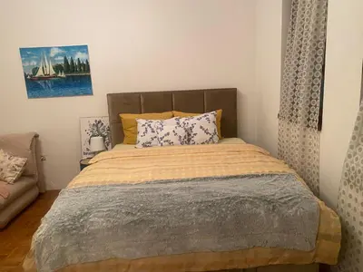 a bedroom with a bed and a couch at Apolon I Apartment in Banja Luka