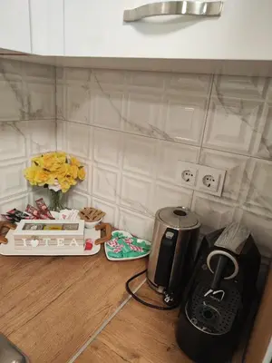 a kitchen counter with a coffee maker on a table at Apartman BULEVAR1 sa garažom in Doboj