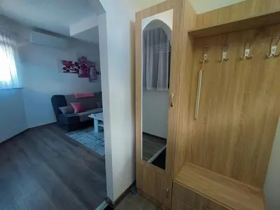 a door in a room with a living room at Apartman Orhideja in Bihać