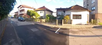 a view of a street with a fence and houses at Apartman Orhideja in Bihać