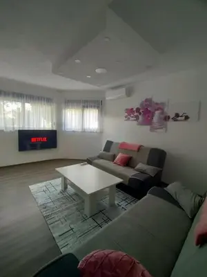 a living room with a couch and a coffee table at Apartman Orhideja in Bihać