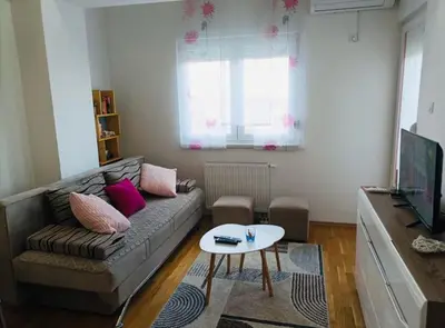 a living room with a couch and a table at Apartman Ema in Banja Luka