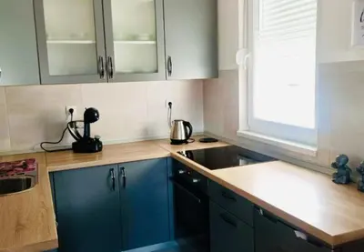 a kitchen with blue cabinets and a sink at Apartman Ema in Banja Luka