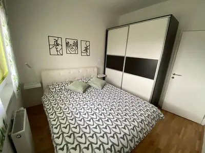 a bedroom with a bed and a large closet at Apartman Ema in Banja Luka
