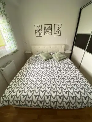 a bedroom with a bed with two pillows on it at Apartman Ema in Banja Luka