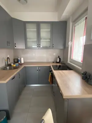 a kitchen with gray cabinets and a sink at Apartman Ema in Banja Luka