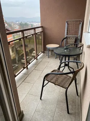 a balcony with a table and chairs and a view at Apartman Ema in Banja Luka