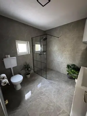 a bathroom with a toilet and a shower with plants at Villa Maglić Vlašić in Vlasic
