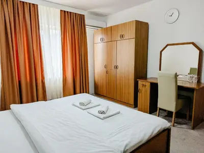 a hotel room with a bed and a desk and a mirror at Motel Dačo in Stara Bila