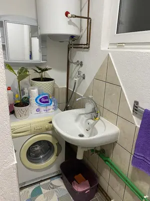 a bathroom with a sink and a toilet at Apartmani Alejna in Sanski most