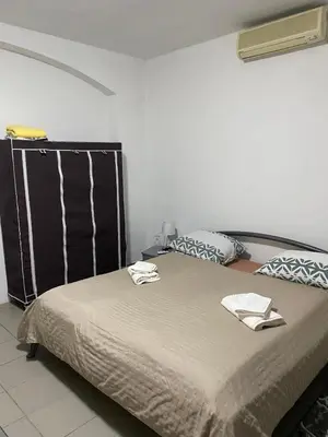 a bedroom with a bed with two towels on it at Apartmani Alejna in Sanski most