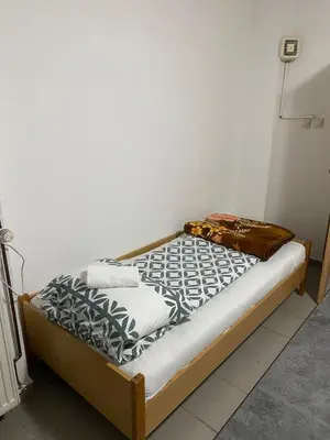 a small bed in a room with a mattress at Apartmani Alejna in Sanski most