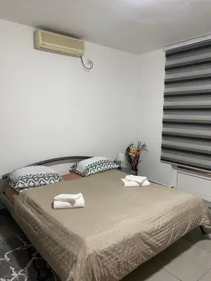 a bedroom with a bed with two towels on it at Apartmani Alejna in Sanski most
