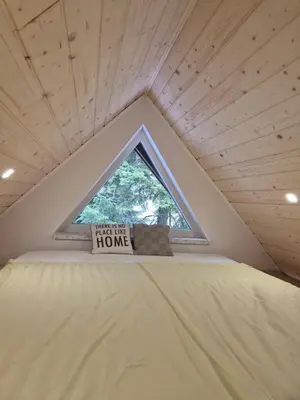 a tiny house with a window on top of a bed at Kuća za odmor Carpe Diem in Bosanski Petrovac