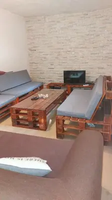 a living room with couches and tables and a tv at Kuća za odmor Carpe Diem in Bosanski Petrovac