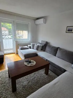 a living room with a couch and a coffee table at Andjelka apartman in Modriča