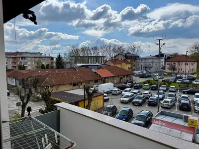 a view of a parking lot with cars parked at Andjelka apartman in Modriča