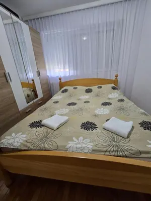 a bed with two pillows on it in a bedroom at Andjelka apartman in Modriča