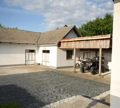 a building with a motorcycle parked in front of it at Apartmani SIMIĆ in Doboj