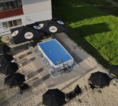 an overhead view of a pool with umbrellas and tables at Apartmani SIMIĆ in Doboj