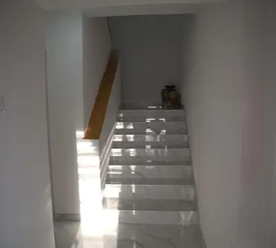 a staircase in a white building with a stair case at Apartmani SIMIĆ in Doboj