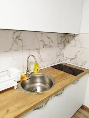 a kitchen with a stainless steel sink in a counter at Boulevard Tuzla Studio Apartment in Tuzla