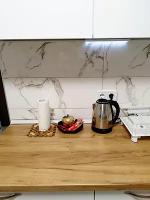 a kitchen counter with a coffee pot on a table at Boulevard Tuzla Studio Apartment in Tuzla