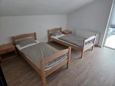 a room with two beds in a room at Villa Voljička in Trnovača