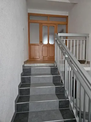 a set of stairs with a wooden door and a wooden door at Villa Voljička in Trnovača