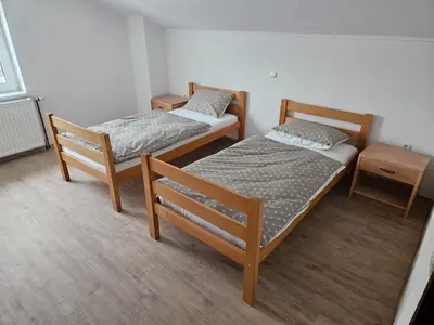two beds in a room with two nightstands and sidx sidx sidx sidx sidx at Villa Voljička in Trnovača