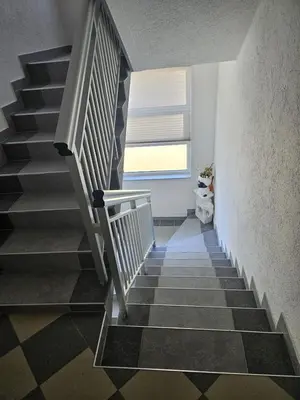a staircase in a house with a window at Villa Voljička in Trnovača