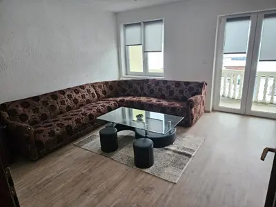 a living room with a couch and a glass table at Villa Voljička in Trnovača