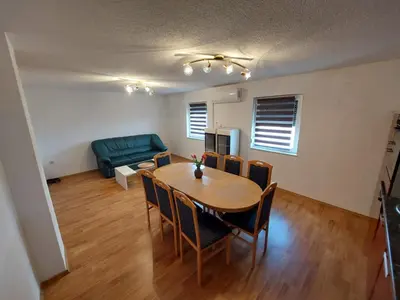 a living room with a table and a couch at Urban home apartments in Bihać
