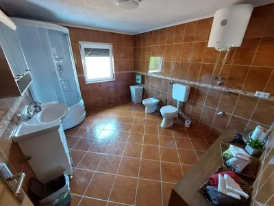 a bathroom with a toilet and a sink at Urban home apartments in Bihać