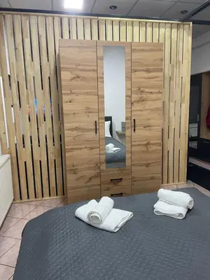 a room with a mirror and two towels on a bed at Apartman ROYAL in Sanski most