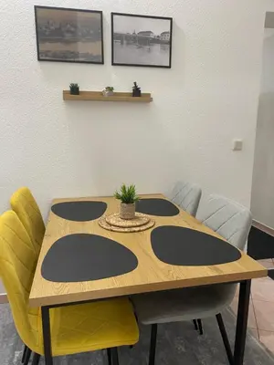 a table in a room with chairs around it at Apartman ROYAL in Sanski most