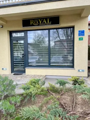 a ryuani store front with a sign in the window at Apartman ROYAL in Sanski most