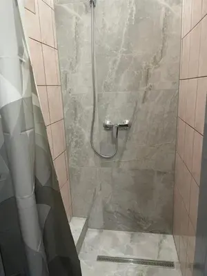 a bathroom with a shower with a glass door at Apartman ROYAL in Sanski most