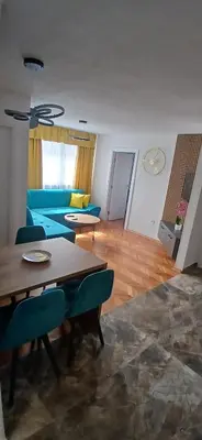 a living room with a blue couch and a table at URBAN apartment Banja Luka in Banja Luka