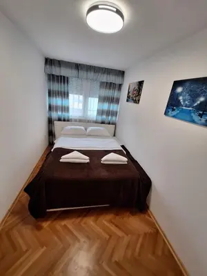a bedroom with a large bed with two pillows on it at URBAN apartment Banja Luka in Banja Luka