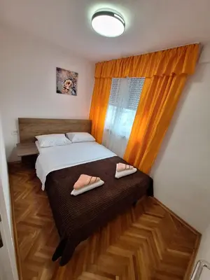 a bedroom with a bed with two slippers on it at URBAN apartment Banja Luka in Banja Luka