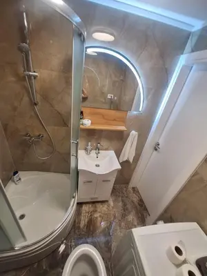 a bathroom with a shower and a toilet and a sink at URBAN apartment Banja Luka in Banja Luka