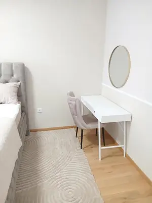 a bedroom with a desk and a mirror and a bed at Palata Suite in Banja Luka