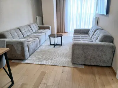 a living room with two couches and a table at Palata Suite in Banja Luka