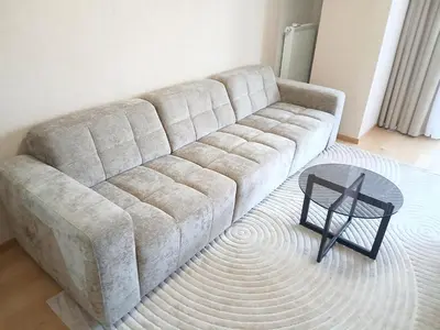a couch in a living room with a table at Palata Suite in Banja Luka