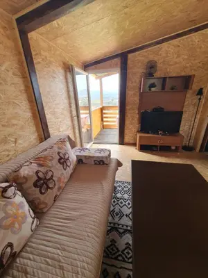 a living room with a couch and a television at Blanca 6 in Nova Bila